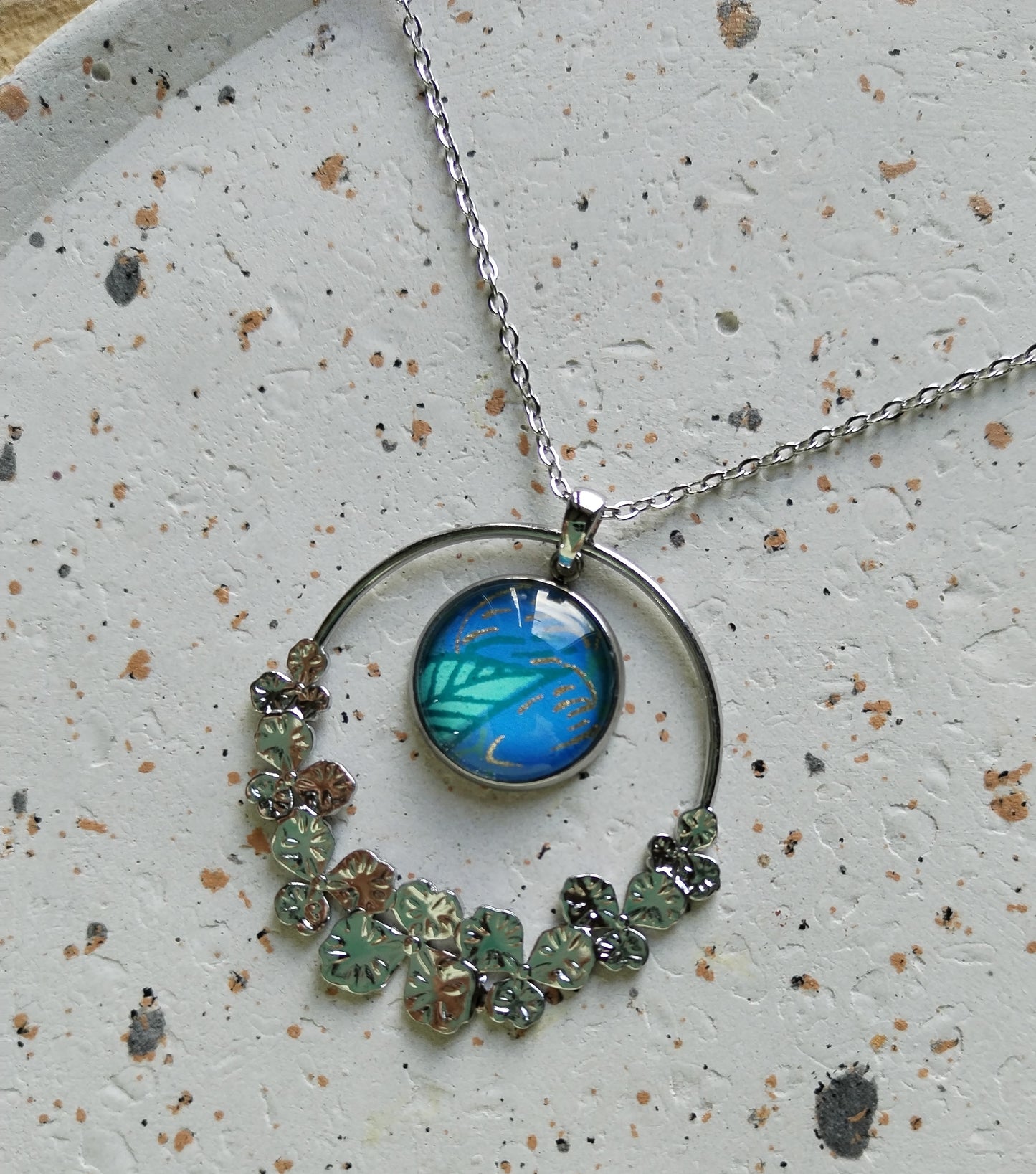 Collier acier bleu fleur et breloque ronde