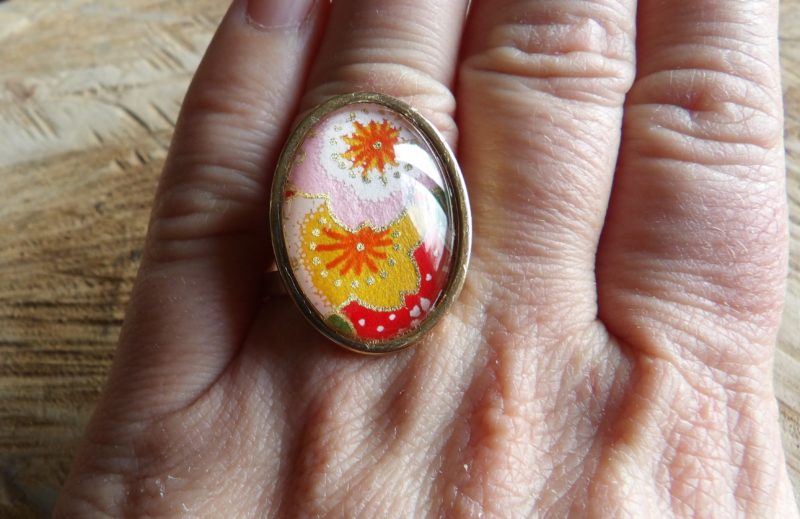 Bague cabochon ovale de 18x25mm - papier japonais fleurs roses, jaunes et rouge - acier inoxydable doré