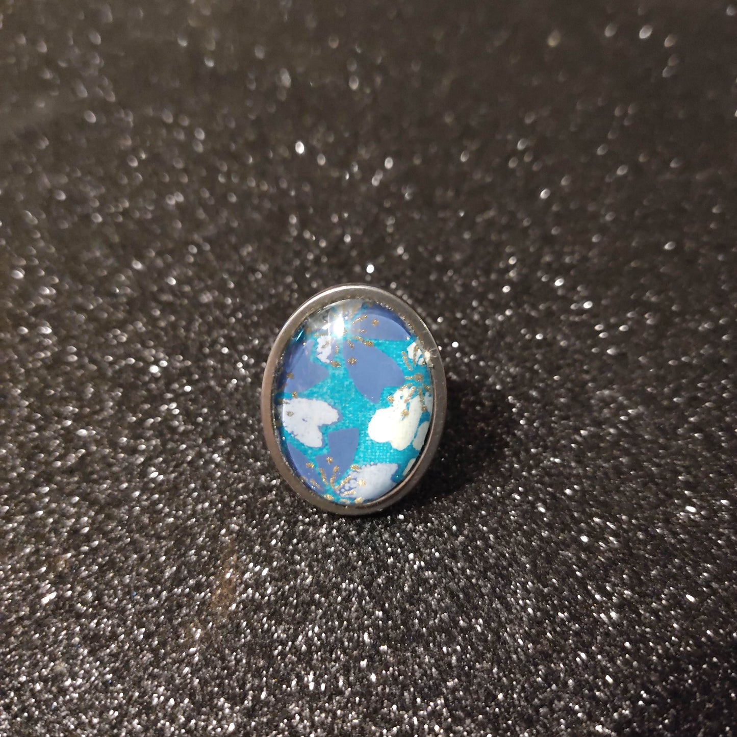 Bague cabochon ovale de 18x25mm - papier japonais fleurs de cerisier blanches et bleues, fond turquoise - acier inoxydable