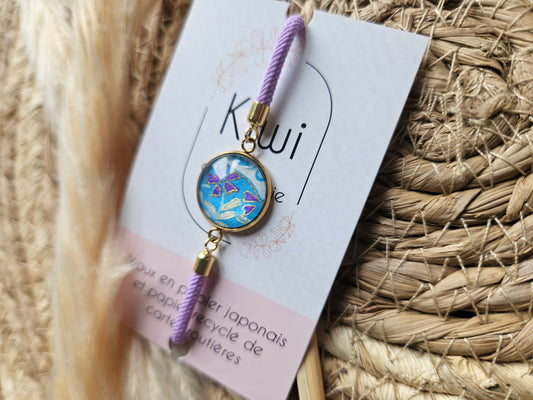 Bracelet mauve réglable et cabochon bleu à fleur violette