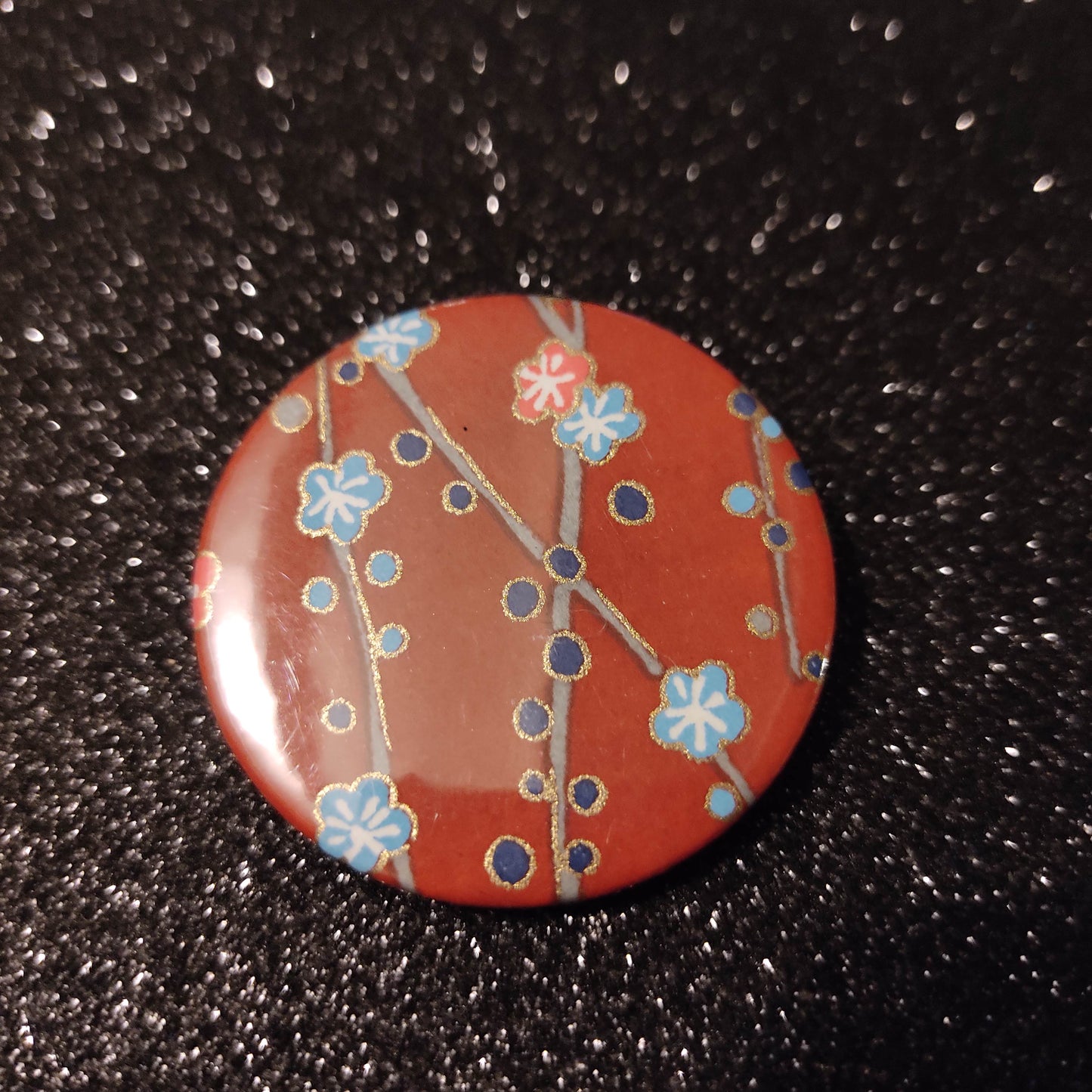 Badge 44 mm - papier japonaise, fleurs bleues et corail, fond rouge