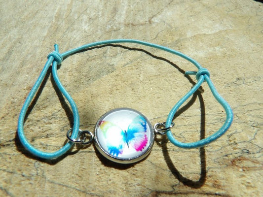 Bracelet élastique bleu cyan avec cabochon papillon 14mm